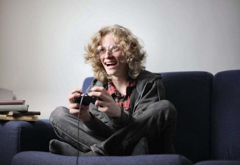 joyful teenager playing video game on tv console