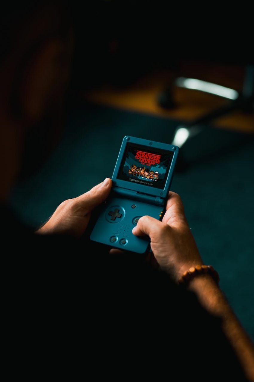 person playing with handheld game console
