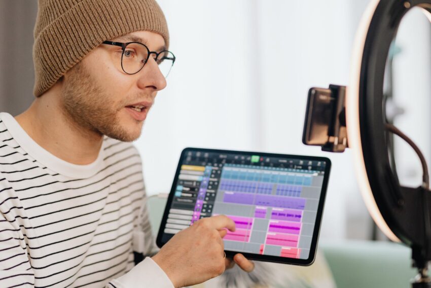 man filming video about creating music on pad