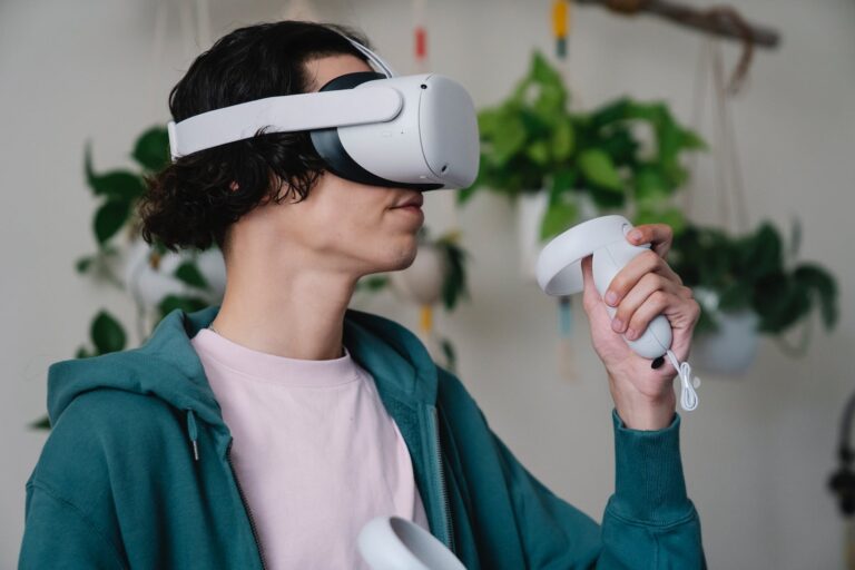 young man playing videogame in vr headset with controller