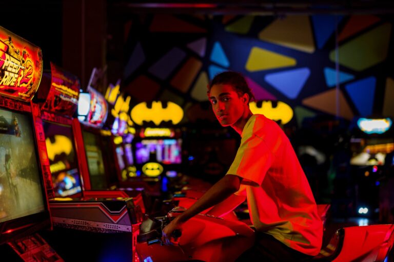 a man playing in an arcade