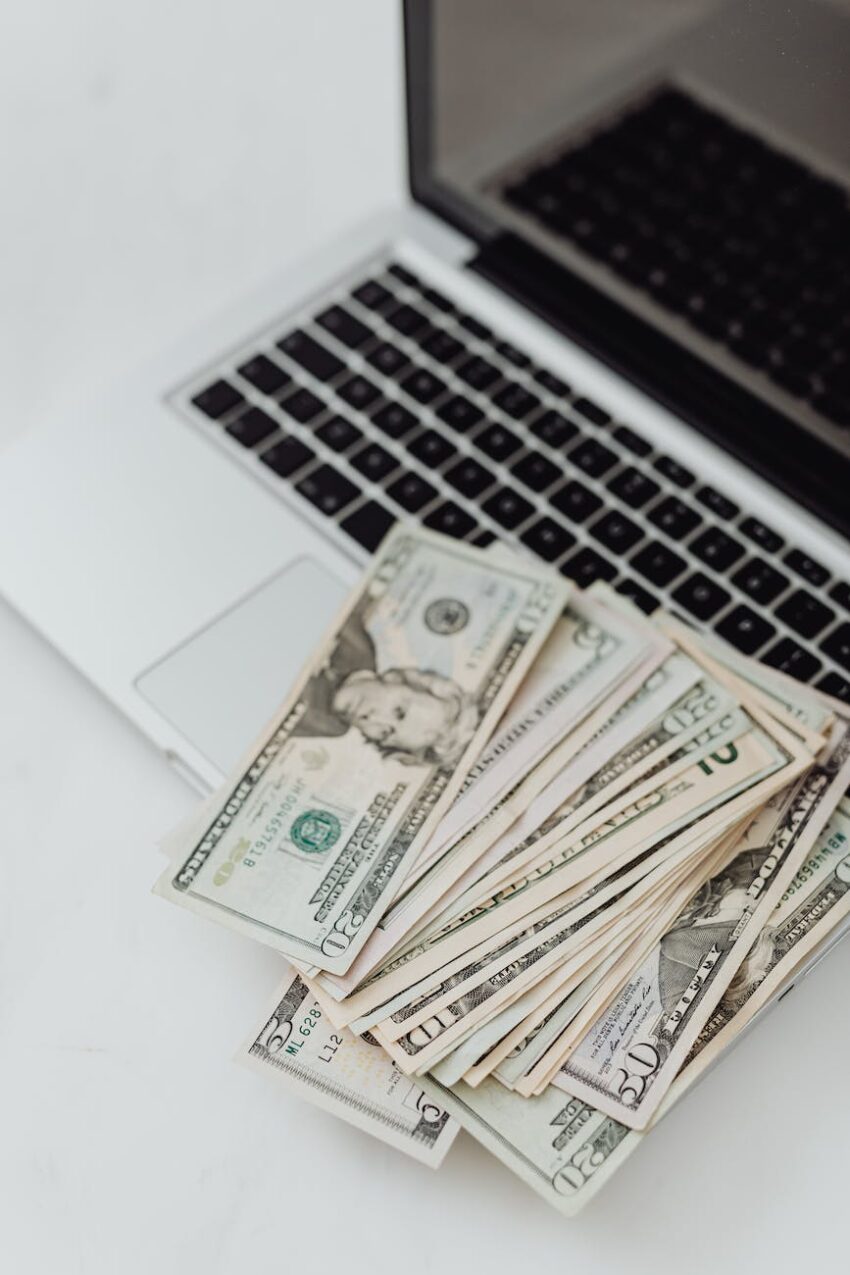 photo of dollar bills on a laptop