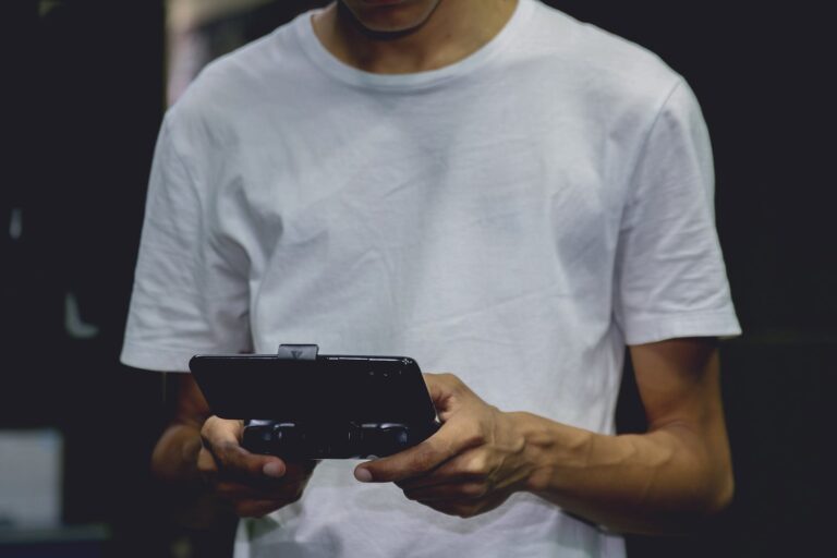 a smartphone game controller on a person s hand